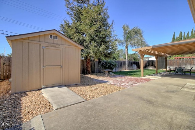 view of yard with a patio, a fenced backyard, an outdoor structure, a pergola, and a shed