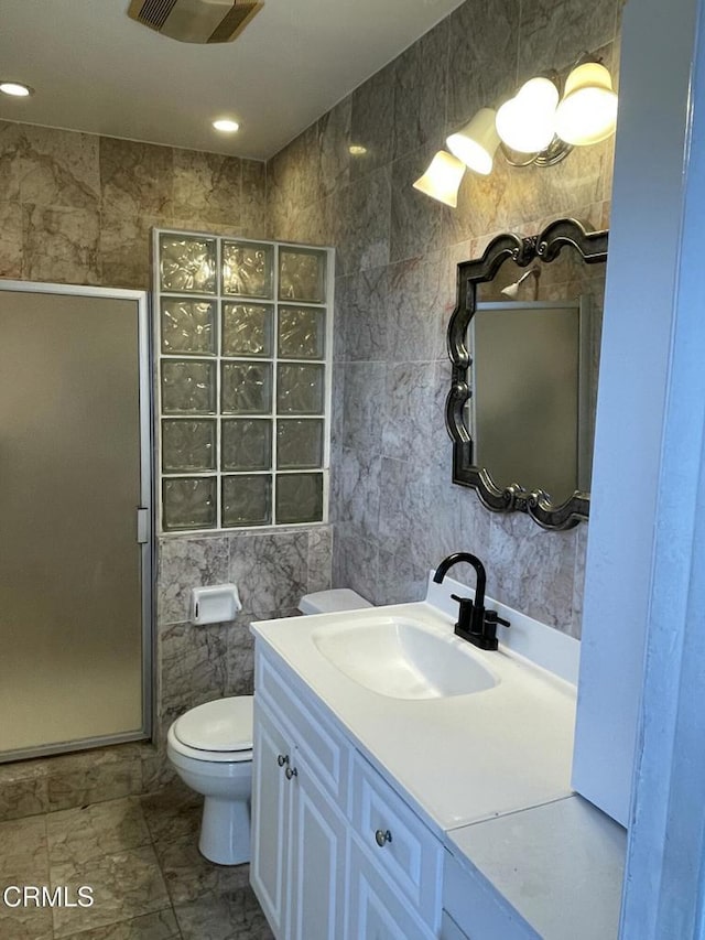 full bathroom featuring toilet, a stall shower, visible vents, and tile walls