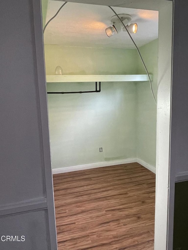 empty room featuring baseboards and wood finished floors