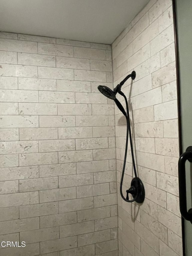 interior details featuring a stall shower