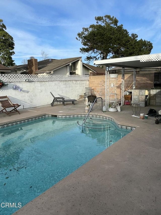 view of pool with a fenced in pool, a patio area, and fence