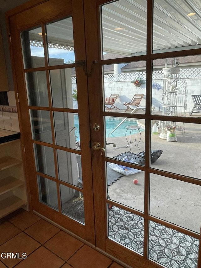 doorway to outside with french doors and tile patterned floors