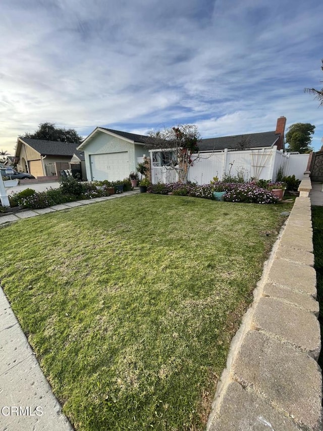 single story home featuring an attached garage, fence, and a front yard