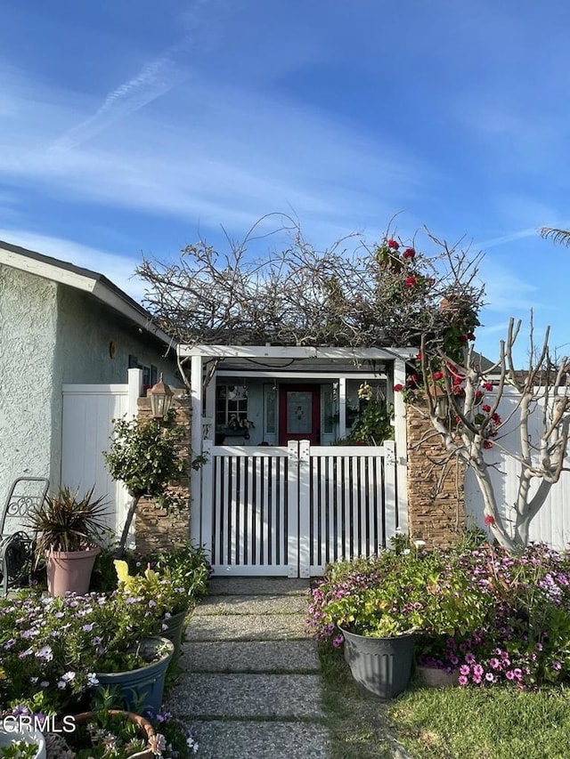 exterior space featuring fence and stucco siding