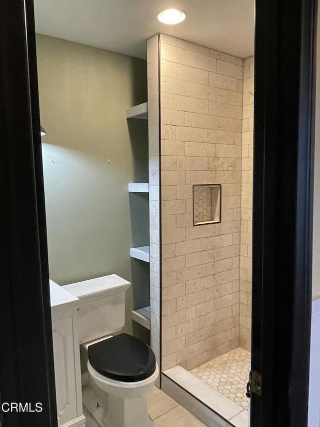 full bath with a stall shower and toilet