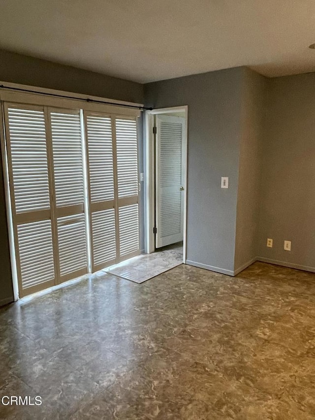 spare room featuring baseboards