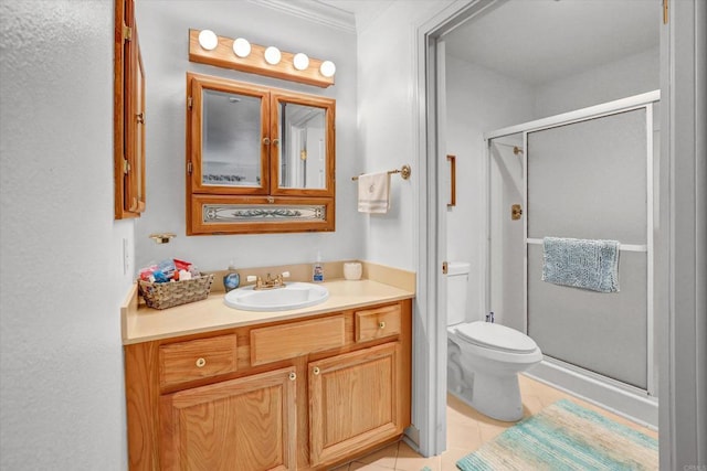 full bathroom featuring toilet, ornamental molding, a stall shower, tile patterned flooring, and vanity