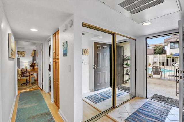 interior space featuring light tile patterned floors, visible vents, baseboards, and recessed lighting