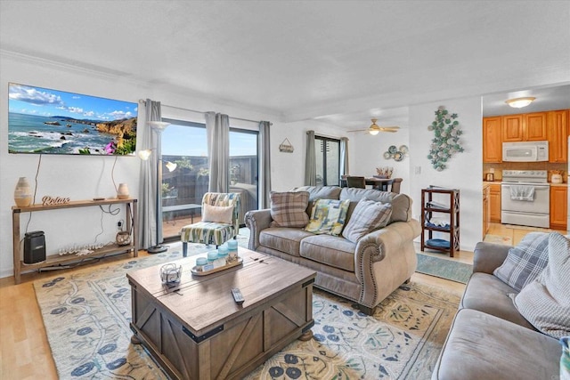 living room featuring light wood-style flooring and ceiling fan