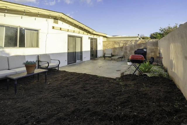 exterior space with a patio area and a fenced backyard