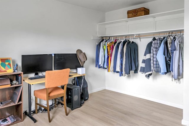 office area with baseboards and wood finished floors