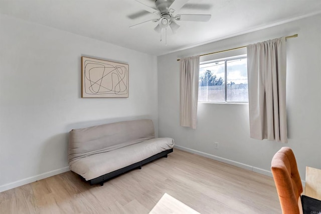 sitting room featuring ceiling fan, baseboards, and wood finished floors