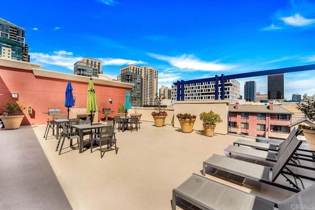 view of patio featuring a view of city and outdoor dining area