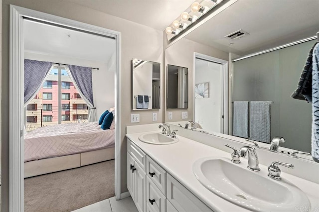 bathroom featuring double vanity, a sink, visible vents, and connected bathroom