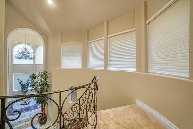 22537 N Summit Ridge Cir, Chatsworth, CA 91311 - hall featuring an upstairs landing, carpet flooring, and a chandelier