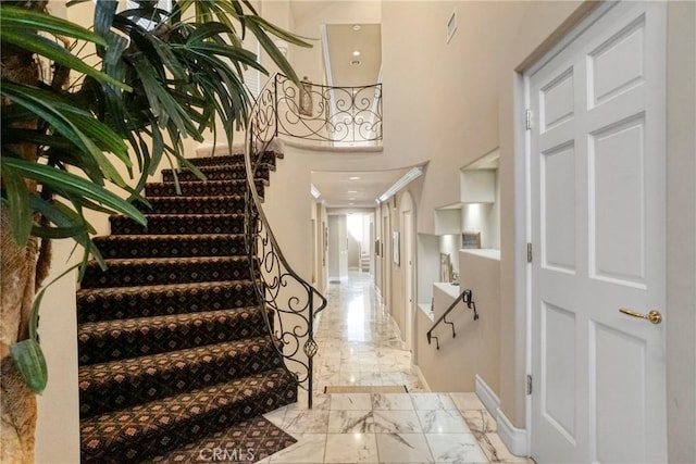 22537 N Summit Ridge Cir, Chatsworth, CA 91311 - foyer entrance featuring marble tiled flooring, baseboards, stairs, and crown molding