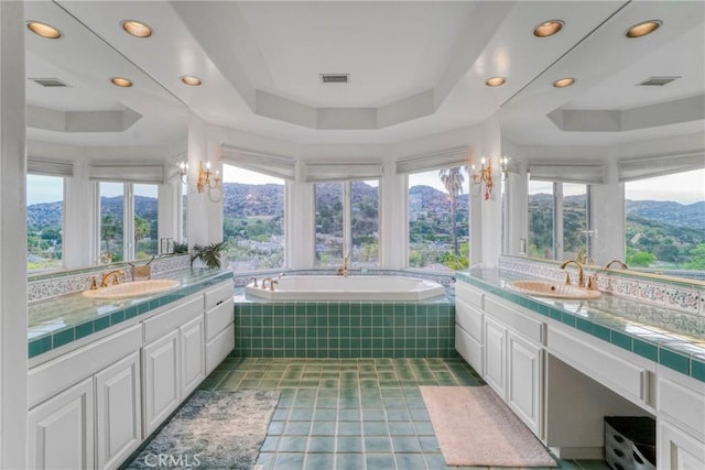 22537 N Summit Ridge Cir, Chatsworth, CA 91311 - bathroom featuring a tray ceiling, healthy amount of natural light, a mountain view, two vanities, and recessed lighting