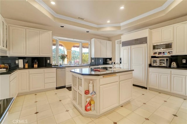 22537 N Summit Ridge Cir, Chatsworth, CA 91311 - kitchen with a raised ceiling, built in appliances, backsplash, an island with sink, and ornamental molding