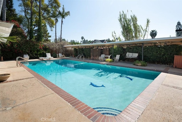 view of swimming pool featuring a fenced in pool, fence, and a patio area