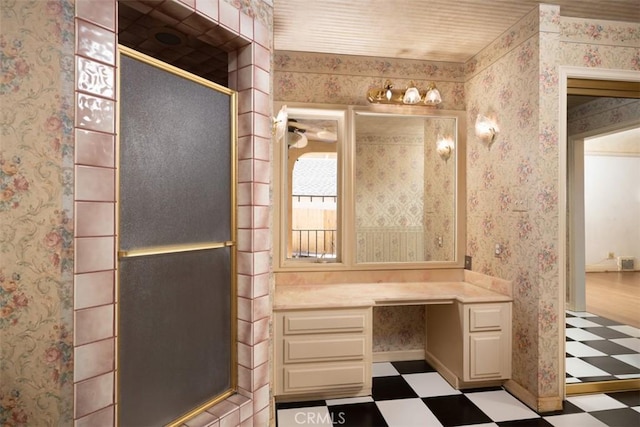 bathroom with tile patterned floors, a shower with door, and wallpapered walls