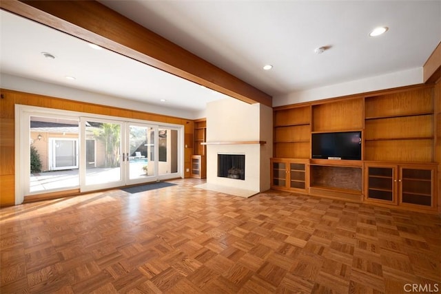 unfurnished living room with french doors, a fireplace with flush hearth, beamed ceiling, and recessed lighting