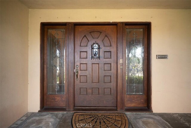 entrance to property with stucco siding