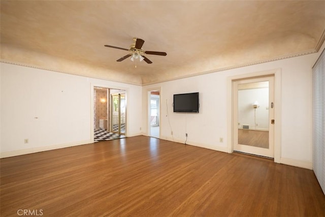 interior space featuring baseboards, ceiling fan, and wood finished floors