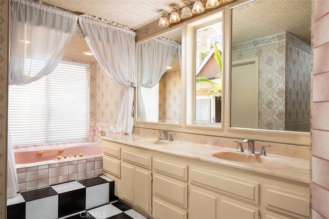 full bathroom featuring double vanity, wallpapered walls, a sink, and a bath