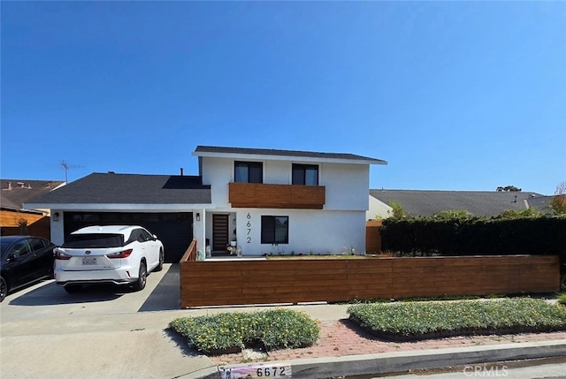 6672 Marilyn Dr, Huntington Beach, CA 92647 - contemporary home featuring a fenced front yard, an attached garage, driveway, and stucco siding