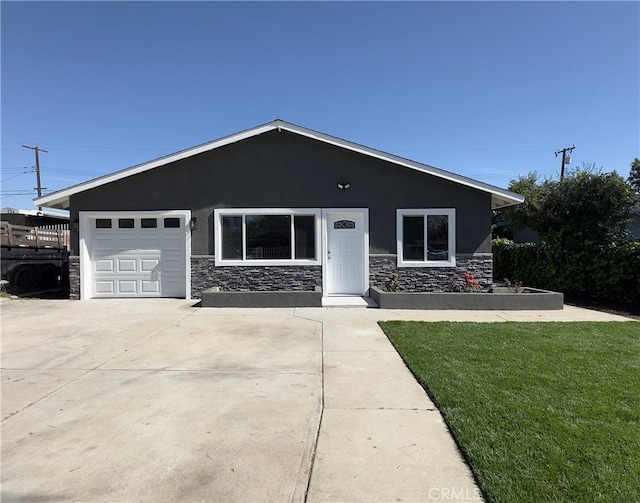 view of front of property featuring stucco siding, a front yard, a garage, stone siding, and driveway