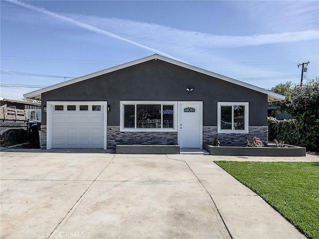 view of front facade featuring stone siding, an attached garage, driveway, and stucco siding