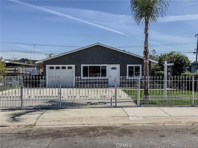 view of front facade featuring a fenced front yard and stucco siding