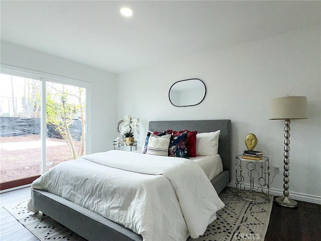 bedroom featuring access to outside, recessed lighting, wood finished floors, and baseboards