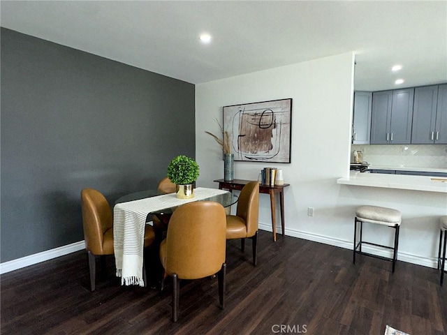 dining room featuring recessed lighting, dark wood finished floors, and baseboards