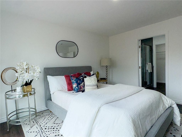 bedroom with baseboards and wood finished floors