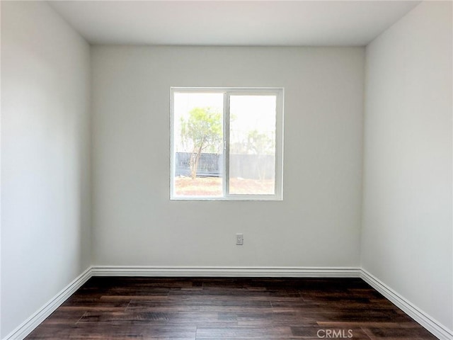 empty room with wood finished floors and baseboards