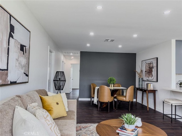 living room with visible vents, wood finished floors, and recessed lighting