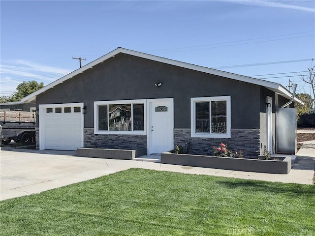 view of front of property with stone siding, a front lawn, concrete driveway, and stucco siding