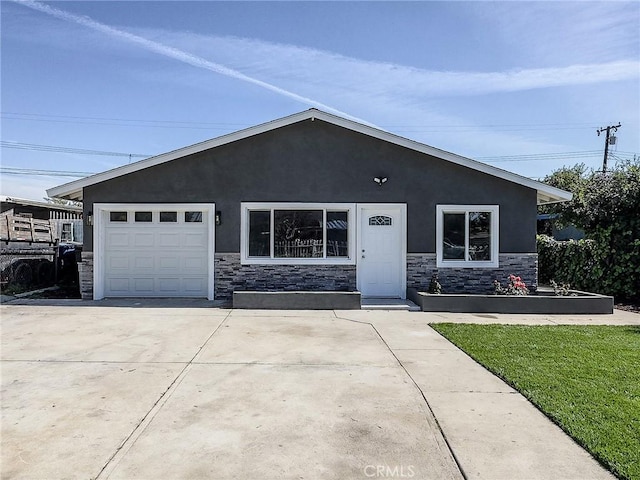 view of front of property with a garage, stone siding, concrete driveway, and stucco siding