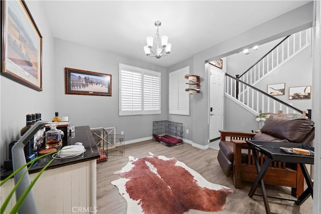 foyer with a chandelier, wood finished floors, stairs, and baseboards