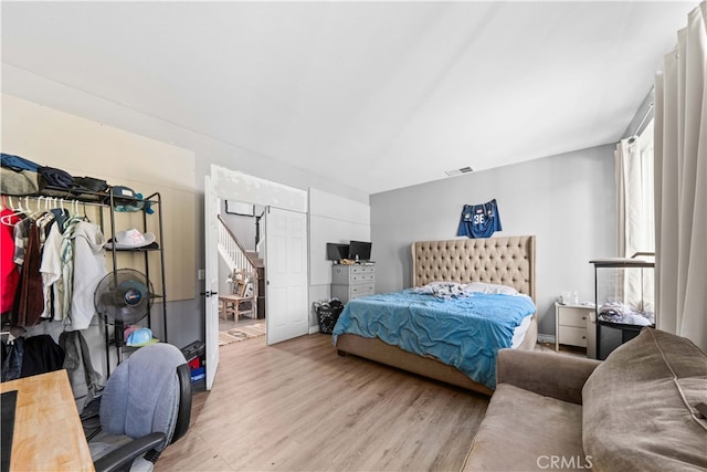 bedroom featuring visible vents and wood finished floors