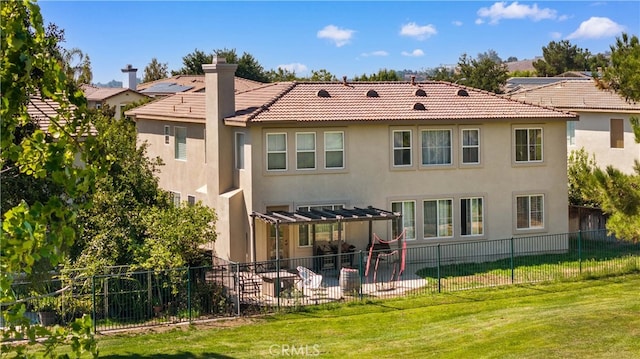 back of house with fence, a yard, a pergola, a chimney, and a patio area