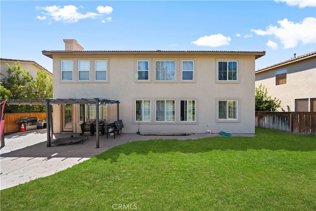 rear view of house featuring a fenced backyard, a pergola, a yard, stucco siding, and a chimney