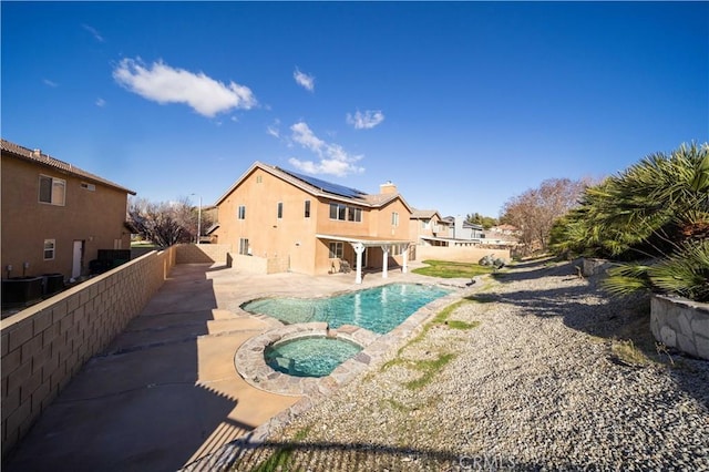 view of pool featuring an in ground hot tub, a fenced backyard, a fenced in pool, and a patio