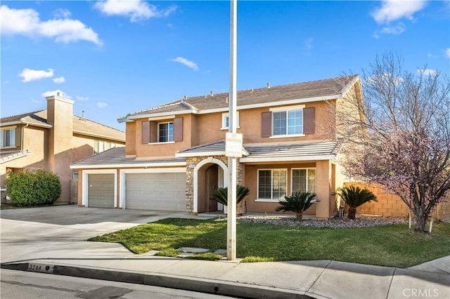 traditional-style house with a front yard, concrete driveway, an attached garage, and stucco siding