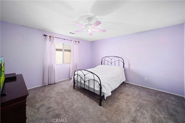 bedroom featuring carpet floors, visible vents, baseboards, and a ceiling fan