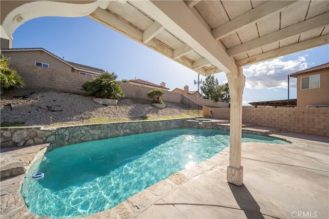 view of pool featuring a patio area, a fenced backyard, and a pool with connected hot tub