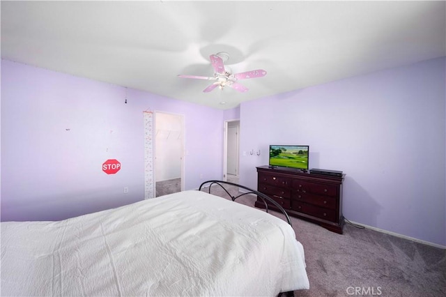 bedroom with a ceiling fan and carpet flooring