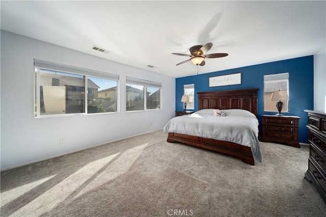 bedroom featuring carpet floors, ceiling fan, and visible vents