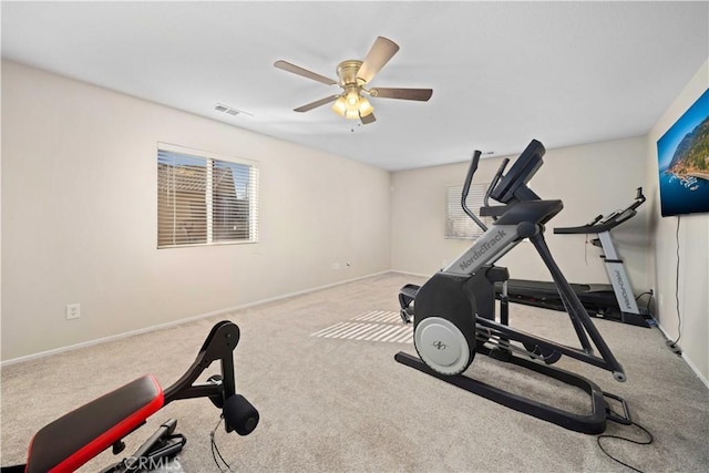 exercise area with carpet floors, visible vents, baseboards, and a ceiling fan